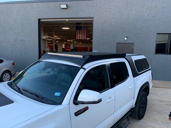 Front right view of Economy Roof rack on a white Toyota Tacoma - Cali Raised LED